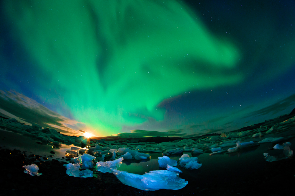 Amazing northern lights performance over glacier lagoon in Iceland during setting moon 