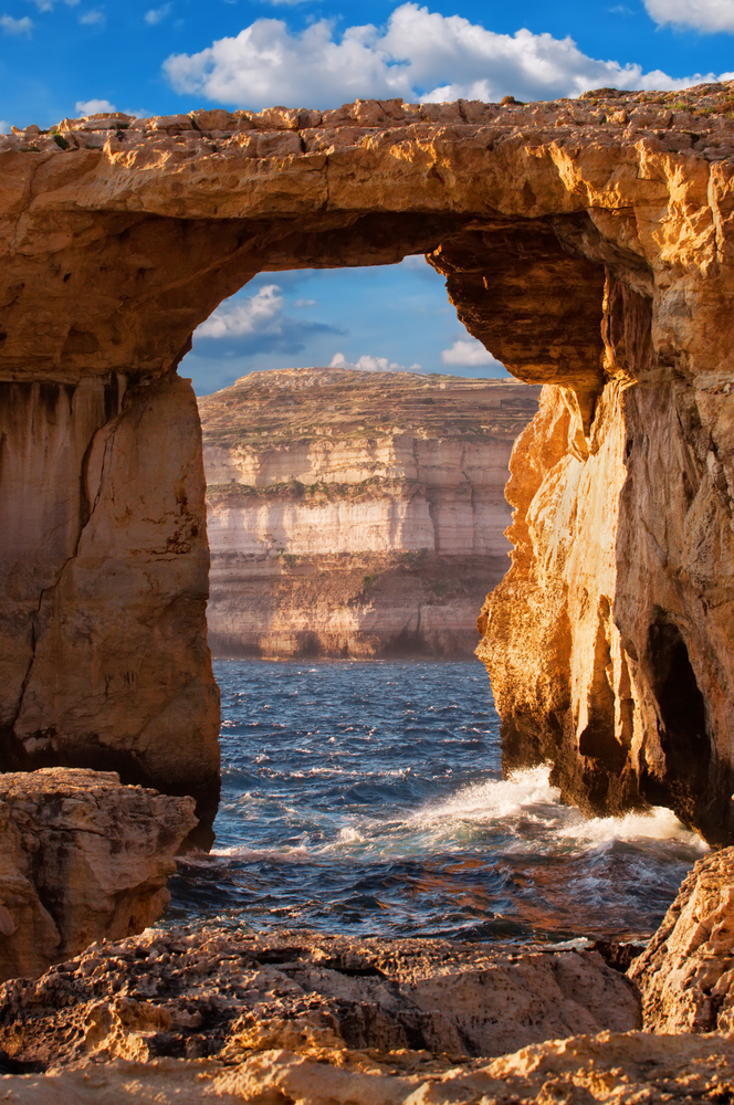 Azure window natural stone arch by Dwejra cliffs at western Gozo island Malta 