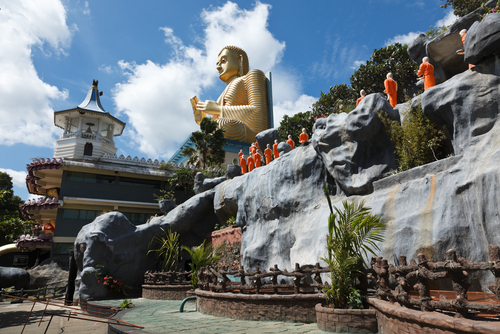 Buddhist monk statues going to Gold Buddha temple Dambulla Sri Lanka