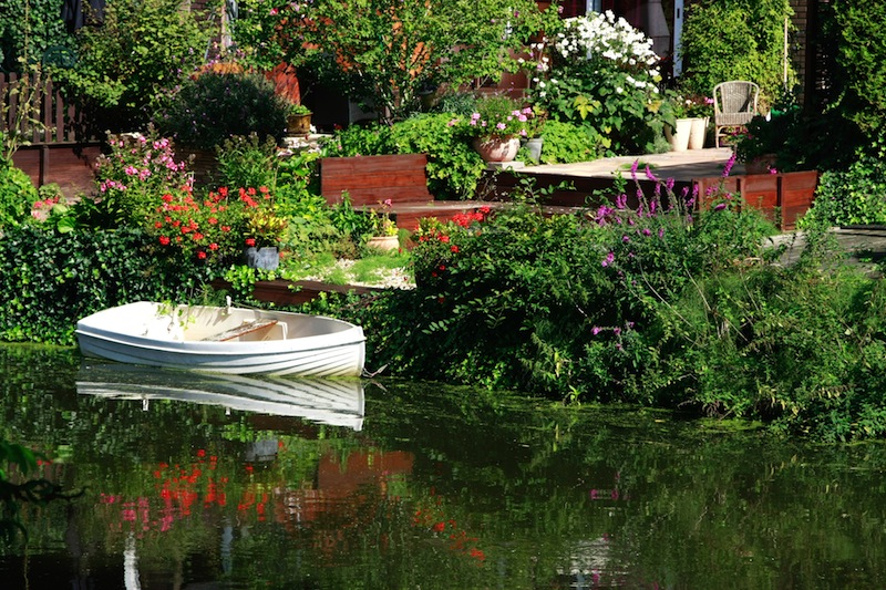 Dutch flower garden with boat on a canal Amsterdam