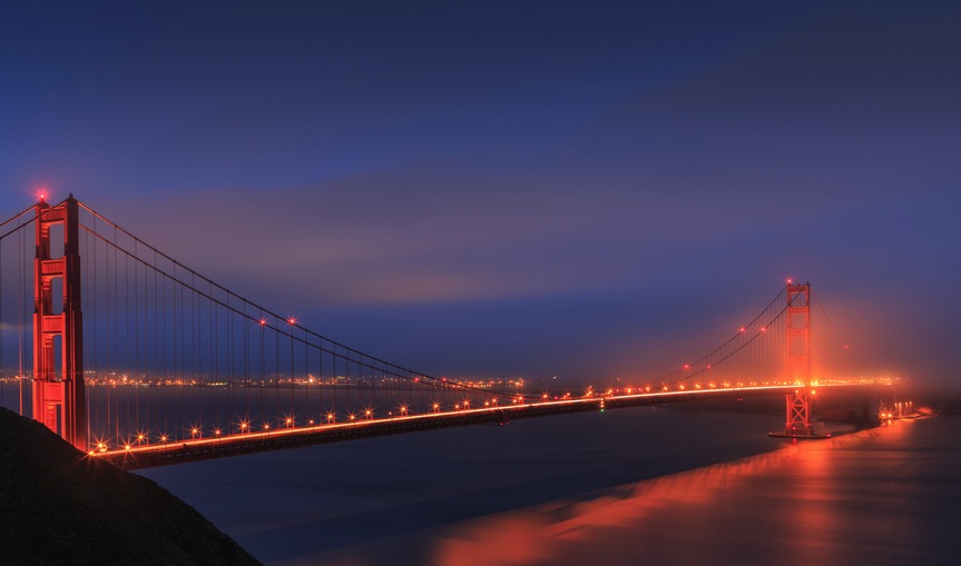 Fog lifting over the Golden Gate Bridge at Sunset 