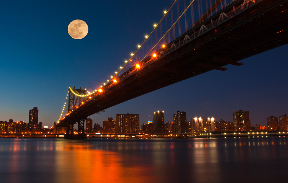 Moon rises over Manhattan Bridge