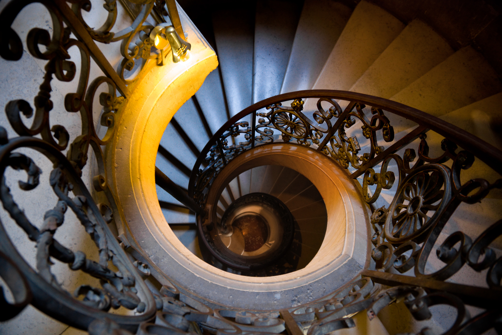 Old wrought spiral staircase in Versailles Chateau