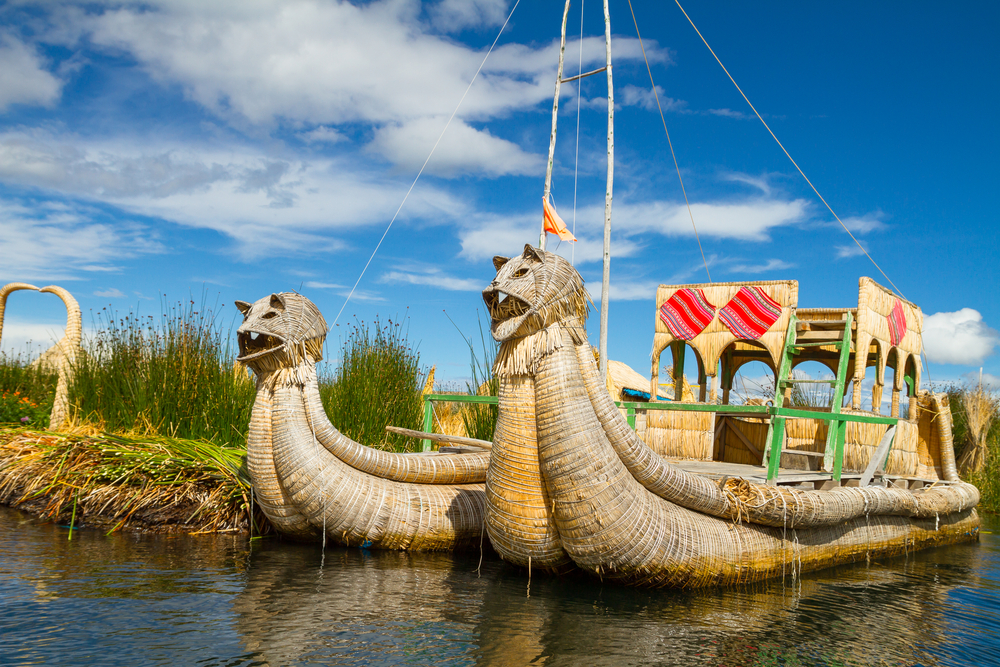 Traditional boats in the floating and tourist Islands of lake Titicaca Puno Peru South America 
