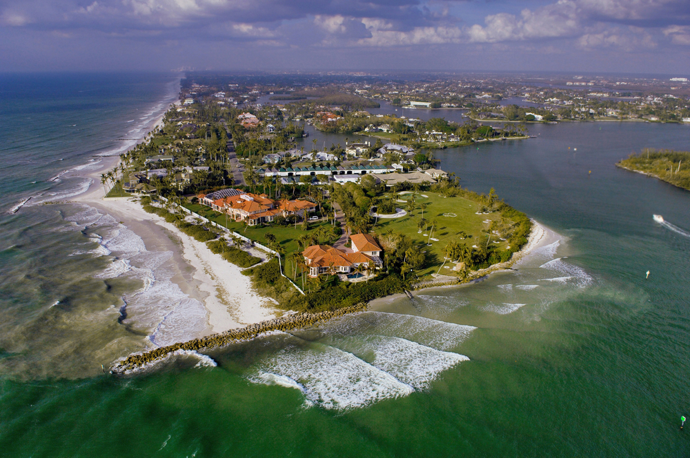aerial view of naples florida gordon pass inlet and luxury waterfront homes 