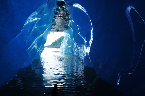 ice cave in an iceberg as looking outside from Valdez Glacier Alaska with water drops 