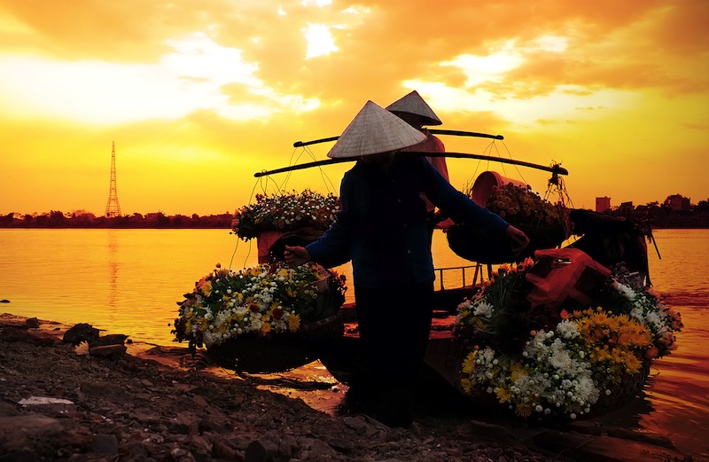 women selling flowers on a boat in the early morning 