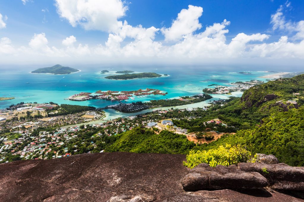 View from Mount Copolia over the east of Mahe Seychelles with the capital Victoria and Eden Island granite rock in the foreground twot 1